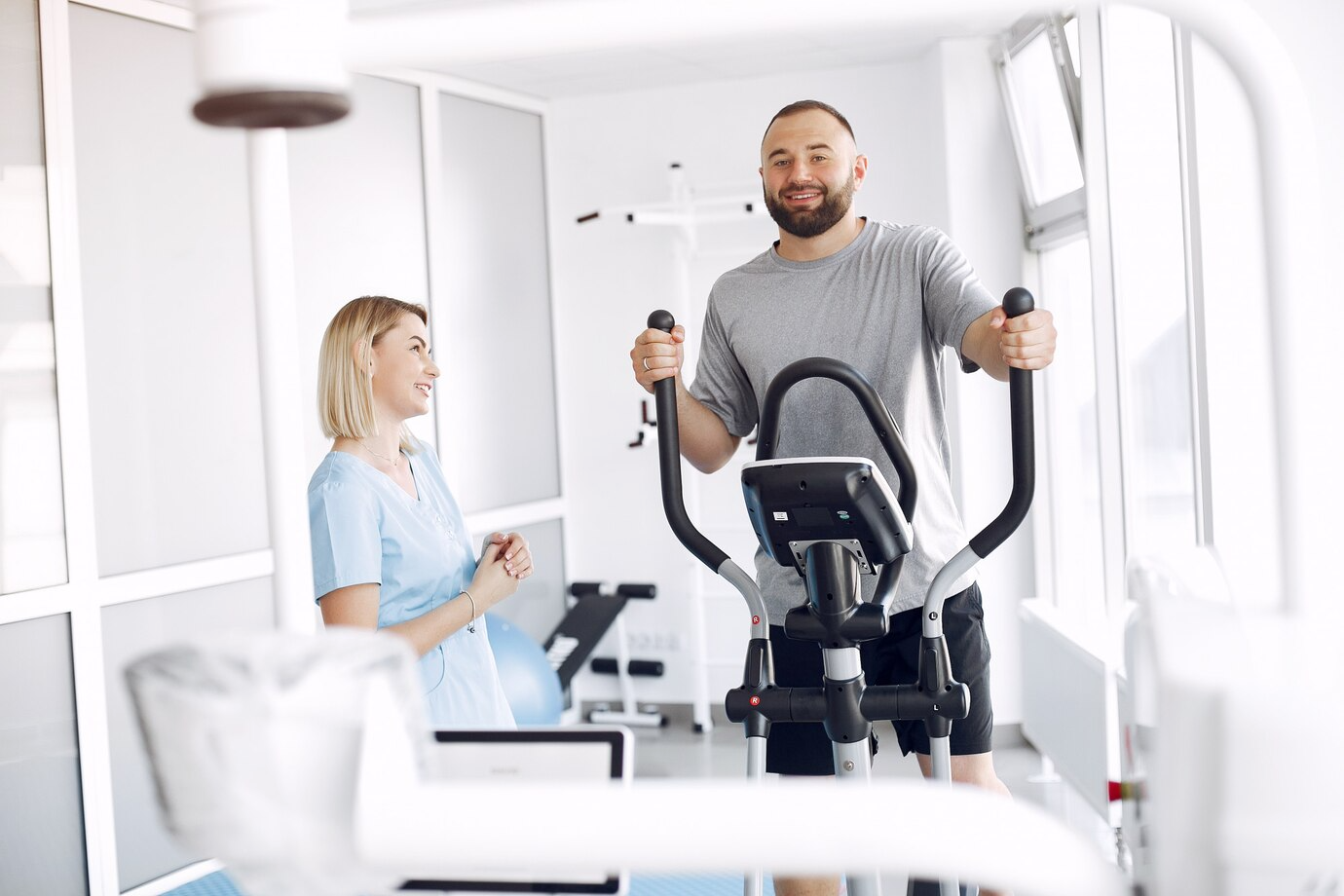 Therapy and Rehabilitation patient doing exercise spin bike gym with therapist 1157 38176