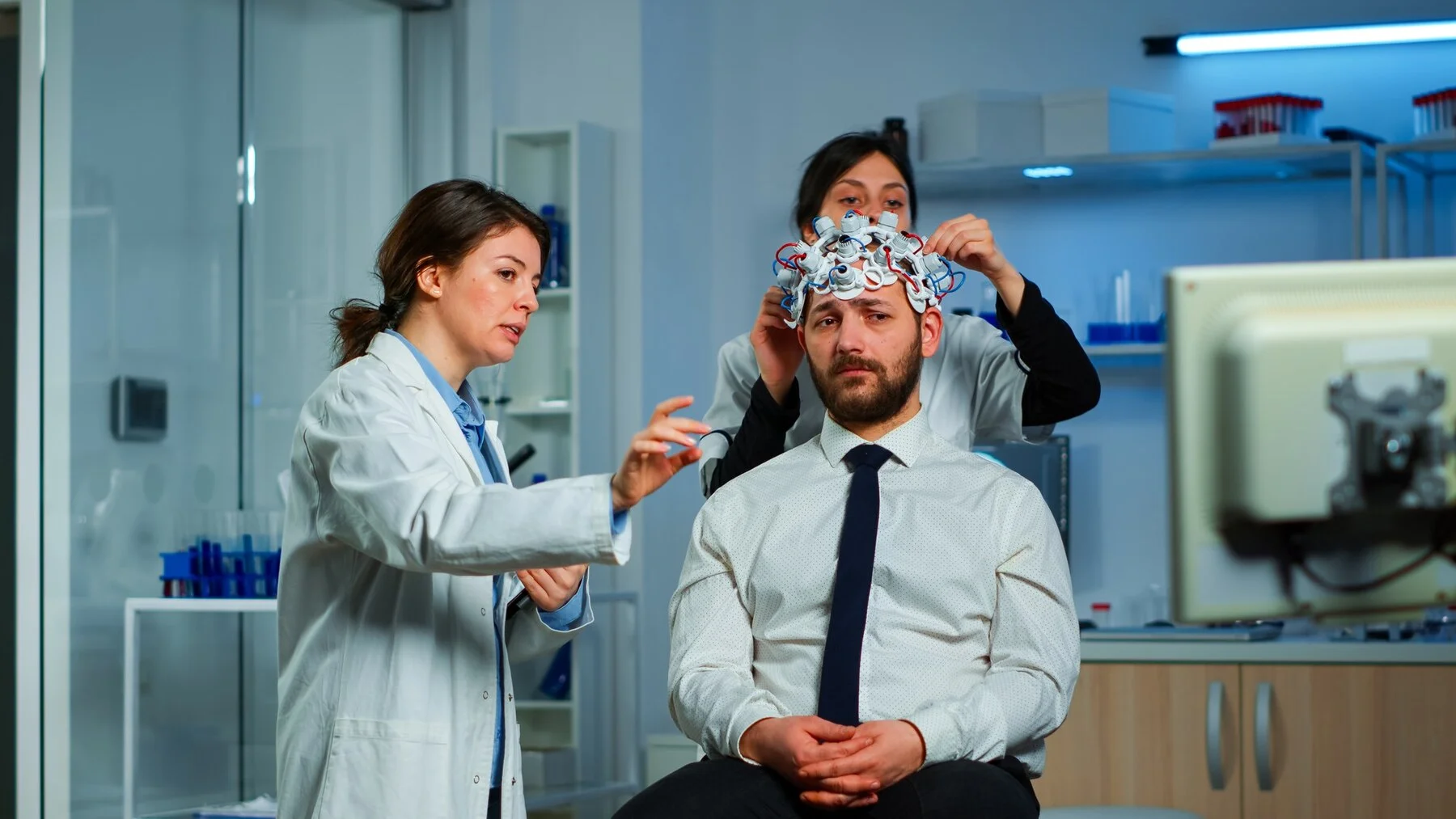 Total Brain Injuries neurological researchers explaning treatment result pointing monitor while medical scientist adjusting brainwave scanning headset preparing brain scan analysing electrical activity 482257 13186