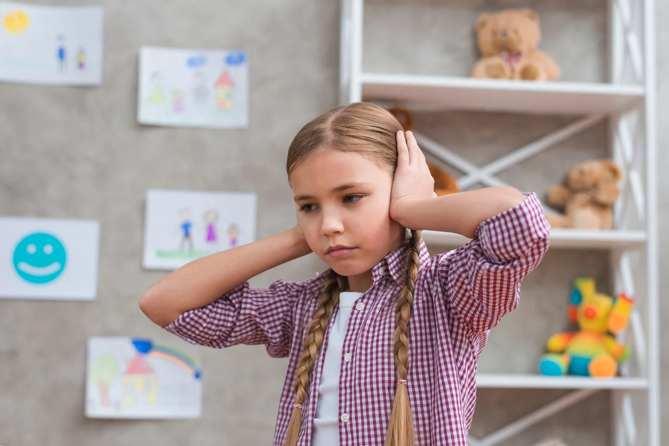 Sensory Processing Disorder portrait sad girl covering her ears with two hands 23 2148026306