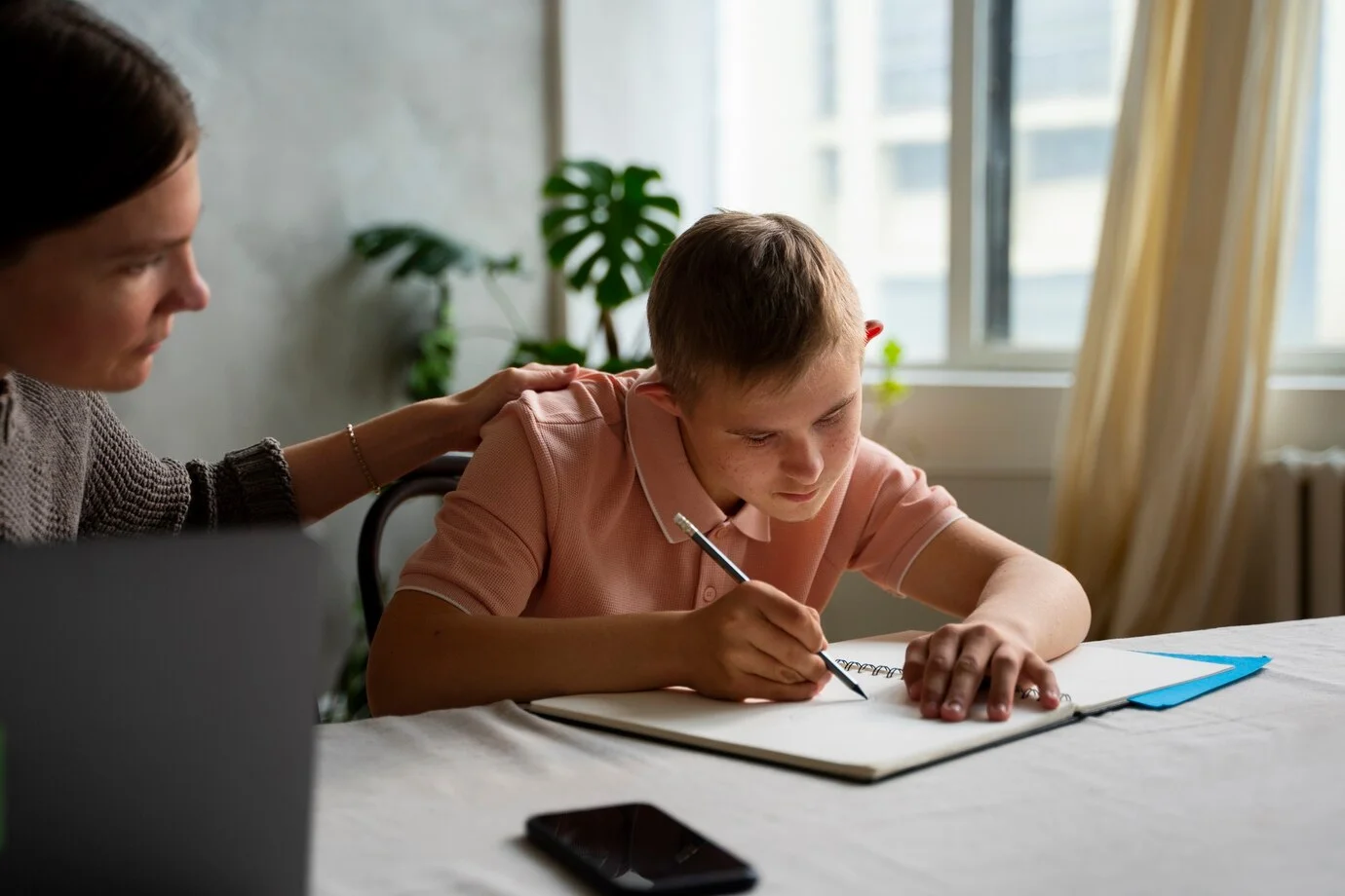 Developmental Delays side view boy woman with laptop 23 2149531837 1